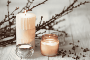 Soy Candles With Dried Flowers On A Wooden Surface.