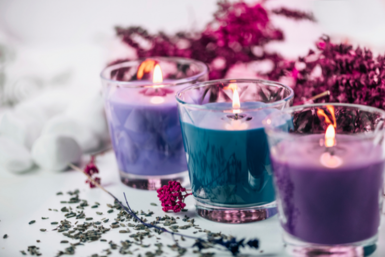Aromatherapy Candles In Purple And Blue Glass Holders Surrounded By Dried Lavender And Flowers, Illustrating The Calming And Mood-Boosting Benefits Of Aromatherapy Candles.
