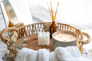 Lighting A Candle: A Soothing Daily Ritual Setup With A Stone Bowl Candle, Bubble Candle, And Reed Diffuser On A Woven Tray, Symbolizing Mindfulness And Self-Care.