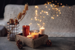 Use Candles: A Cozy, Ambient Candle Setup With Various Candle Sizes In A Rustic Wooden Tray, Paired With Pinecones And Soft Bokeh Lights—Perfect For Inspiring Magical Home Rituals.